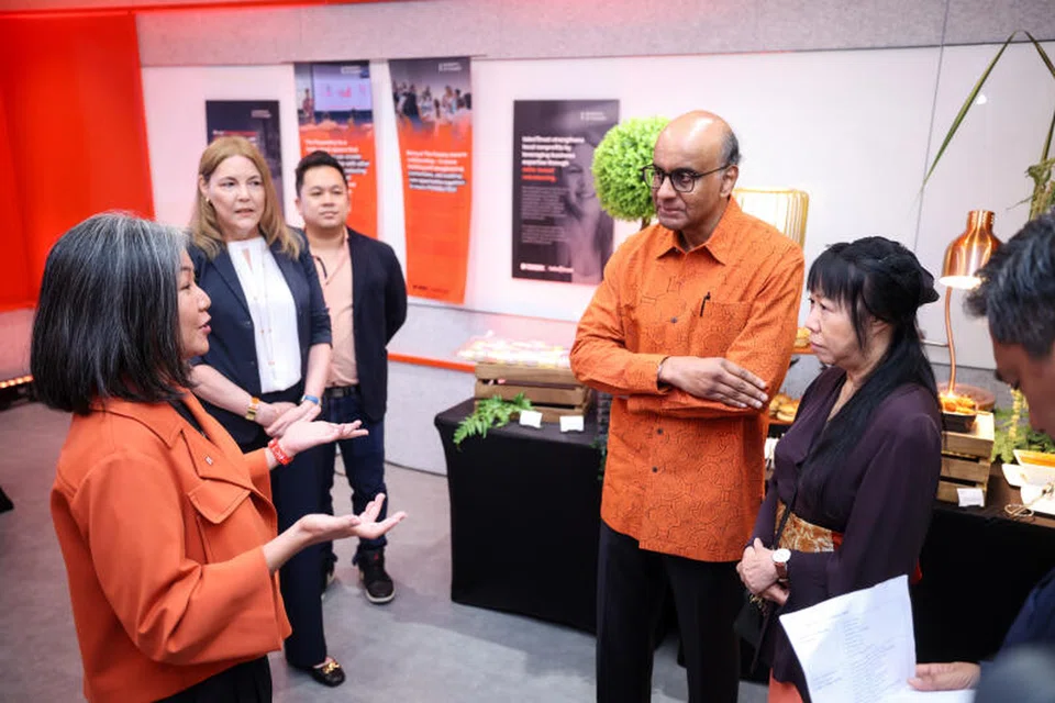 Presiden Tharman Shanmugaratnam bersama isterinya, Puan Jane Ittogi (kanan), berinteraksi bersama wakil beberapa pertubuhan sosial seperti Timbalan Pengurus Besar Ray Of Hope, Cik Alicia Altofer-Ong (kiri), semasa dibawa mengeililing hab perusahaan baru, The Foundry, pada 28 November.