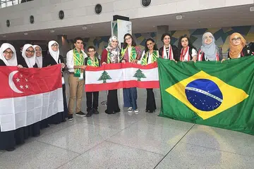KUALITI DIPUJI: Penguasaan bahasa Arab dan pembentangan idea yang kritikal dan jelas para pelajar Madrasah Aljunied Al-Islamiah yang mewakili Singapura dalam pertandingan bahas Arab di Qatar ini dipuji para peserta dan pengadil. Mewakili negara (dari kiri) Nur Zuhaidah Md Yusof, Nurhani Rehan, Nabilah Farhah Ali dan Naheedah Reza Jalalrahman bersama pembahas dari Lebanon dan Brazil. - Foto ihsan USTAZAH HARINAH ABDUL LATIFF