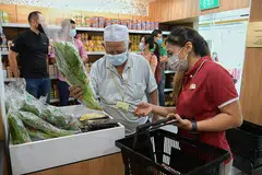 DARI KEBUN KE KELUARGA: Benefisiari di Boon Lay dapat memilih hingga tujuh hasil tempatan segar, seperti tiga jenis sayur-sayuran, dua jenis cendawan, telur puyuh dan telur, di kedai masyarakat Food from the Heart. - Foto BH oleh NG SOR LUAN.