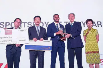 PENCAPAIAN DIIKRIRAF: Sheik Farhan (dua dari kiri) menerima Anugerah Atlit-Pelajar Lelaki Terbaik daripada DPM Teo. Bersama dalam gambar ialah Encik Tan dan Cik Fu. - Foto SNOC