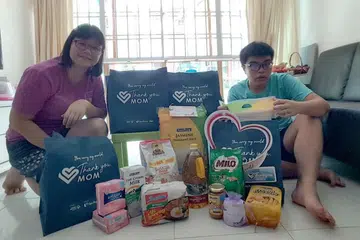 HARGAI IBU: Cik Chan Kam Ling, ibu kepada atlet Olimpik Khas, Jeremy Yeo Zhi Hui, bersama pek penjagaan P&G.