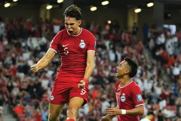 Jacob Mahler (kiri) meraikan gol penyamaan Singapura menentang China bersama rakan sepasukan, Faris Ramli, dalam aksi kelayakan Piala Dunia di Stadium Negara pada 21 Mac. Keputusan kekal 2-2 sehingga tamat perlawanan.