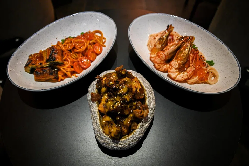 RASA SEIMBANG DAN LAZAT: (Dari kiri) Hidangan Korea-Jepun di restoran Yaksok termasuk ‘Spicy Guchunagi Pasta’ ($25), ‘Bulgogi Tater Tots’ ($12) dan ‘Mentaiko Prawn Pasta’ ($25). 
