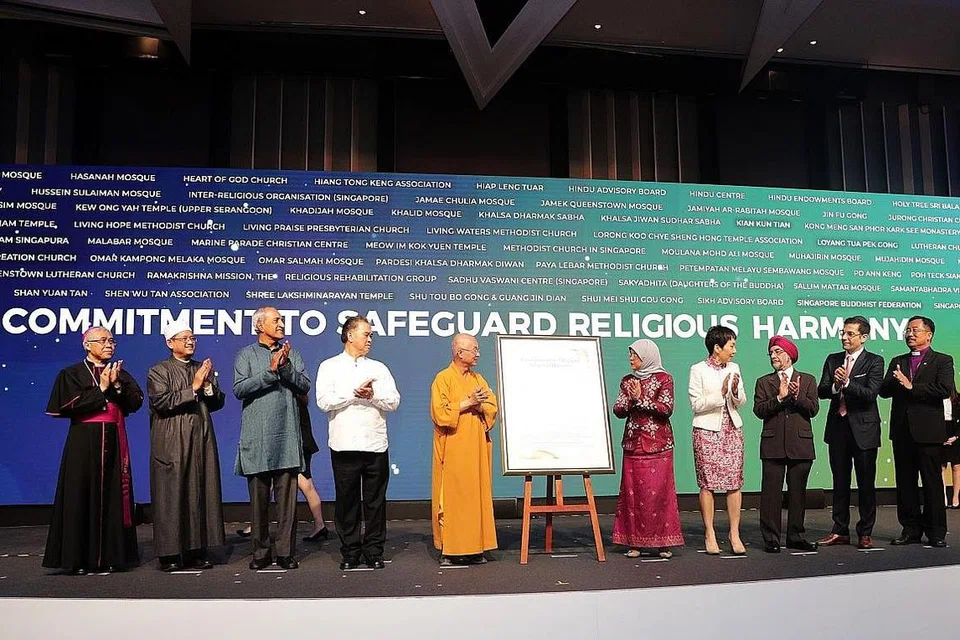 ERATKAN HUBUNGAN: Presiden Halimah Yacob (lima dari kanan) bersama pemimpin agama menyampaikan ikrar melindungi keharmonian agama bersama (dari kiri) Biskop Besar William Goh daripada Catholic Archdiocese of Singapore; Mufti Dr Mohamed Fatris Bakaram; Pengerusi Lembaga Penasihat Hindu, Encik Rajan Krishnan; Pengerusi Persekutuan Tao Singapura, Encik Tan Thiam Lye; Presiden Persekutuan Buddha Singapura, Venerable Seck Kwang Phing; Menteri Kebudayaan, Masyarakat dan Belia, Cik Grace Fu; Pengerusi Lembaga Penasihat Sikh, Encik Surjit Singh; Presiden Pertubuhan Antara Agama (IRO), Encik Ben J. Benjamin; dan Presiden Majlis Gereja Kebangsaan Singapura, Biskop Terry Kee. - Foto BH oleh KELVIN CHNG 