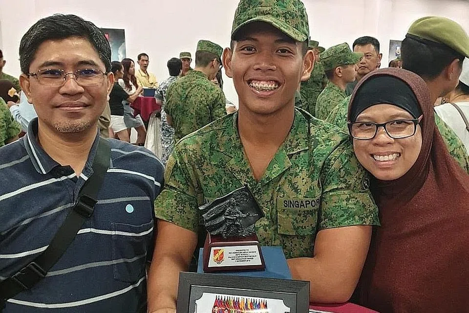 TUNGGAK KEKUATAN: 2LT Ammar bersama ibu bapanya setelah selesai menjalani latihan BMT yang menyaksikan beliau dinobat rekrut terbaik kompeninya. - Foto MINDEF