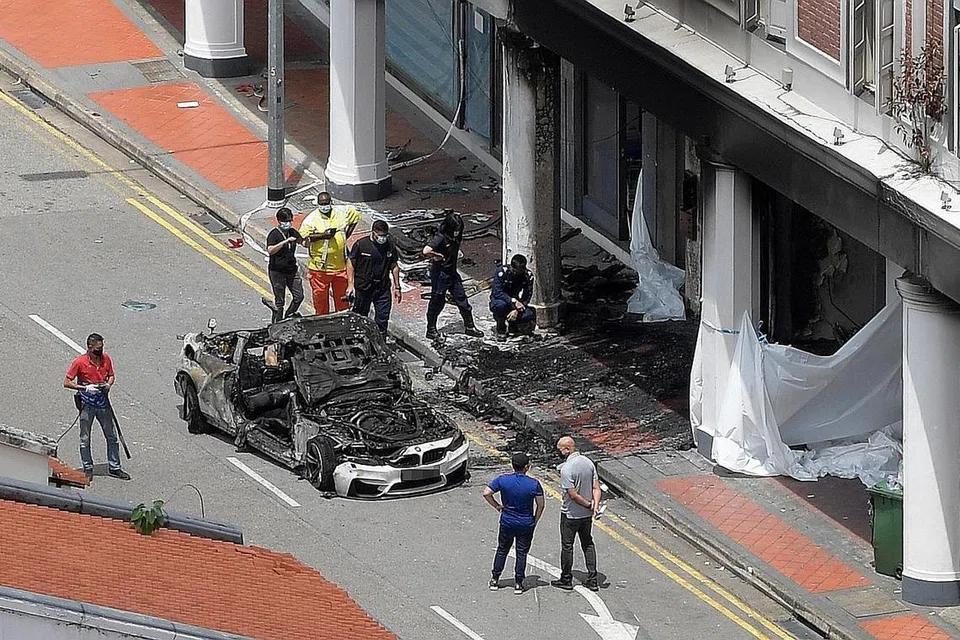 KEMALANGAN MAUT: Encik Long memandu kereta BMW M4 berwarna putih pada sekitar 5.40 pagi apabila ia merempuh sebuah rumah kedai sebelum terbakar (gambar atas). - Foto-foto fail, PEMBACA ST