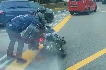 Seorang pengguna TikTok @mikeshary dilihat membantu seorang penunggang motosikal selepas motosikalnya tumbang berhampiran lorong penggabungan menuju ke jalan utama.