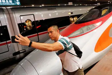 MUDAHKAN PERJALANAN: Penumpang ini sempat 'berselfie' dengan kereta api berkelajuan laju yang menghubungkan Hongkong dengan China dan mula beroperasi pada 23 September lalu. - Foto REUTERS 