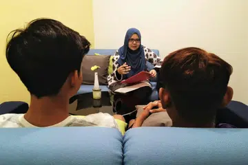 SESI KAUNSELING: Seorang kaunselor berinteraksi dengan dua belia semasa sesi kaunseling yang diadakan.