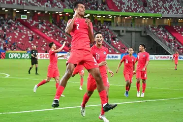 PERLU BERSATU: Shakir (tengah, gambar atas) meraikan golnya dalam kemenangan 2-0 Singapura ke atas Timor Leste di Stadium Negara malam kelmarin. - Foto BH oleh DESMOND WEE