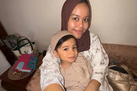 Cik Azhani Fisal, 28 tahun, menjaga anak saudaranya, adik Alwee Faeyza Muhammad Ikram yang kini berusia dua tahun, setelah kehilangan kedua-dua ibu bapanya.
