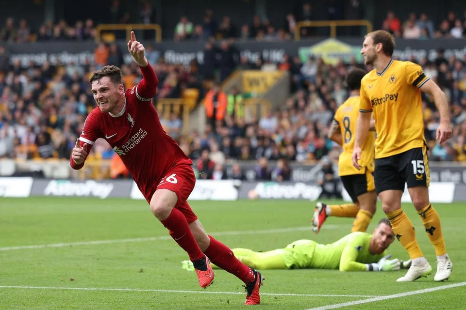 BANGKIT UNTUK MENANG: Andrew Robertson (jersi merah) menjaringkan gol kedua Liverpool dalam kemenangan 3-1 ke atas Wolves.
