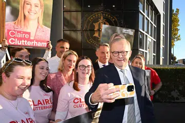 Perdana Menteri Australia, Anthony Albanese (kanan), dan calon Parti Buruh bagi kawasan Sturt, Claire Clutterham (lima dari kiri), bergambar swafoto bersama sukarelawan semasa lawatan ke pusat pengundian awal di kawasan pilihan raya Sturt, Adelaide, pada 1 Mei 2025. Pilihan raya persekutuan Australia 2025 dijadual berlangsung pada 3 Mei bagi memilih ahli Parlimen ke-48 negara itu.