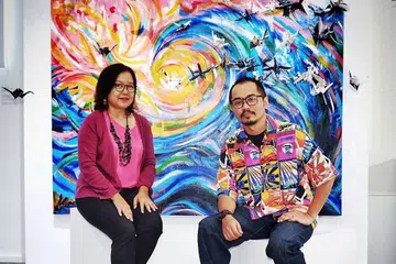 BELAJAR ERTI KERJASAMA: Cik Masturah Sha'ari (kiri) dan Encik Dino Hafian saling belajar nilai kesabaran, tolak ansur dan perpaduan idea dalam menyiapkan karya berdasarkan dua puisi pengasas bersama Angkatan Pelukis Aneka Daya (Apad), Allahyarham Abdul Ghani Hamid. - Foto BH oleh KHALID BABA 