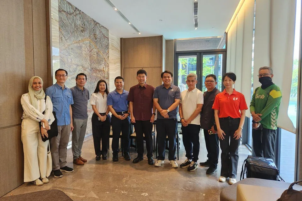 Menteri Pembangunan Negara, Encik Desmond Lee (lima dari kiri) dan Menteri Pengangkutan, Encik Chee Hong Tat (enam dari kiri), bersama wakil kumpulan kerja tiga pihak semasa melawat pusat beli-belah Jurong Point dan kondominium Lake Grande pada 19 Julai. 