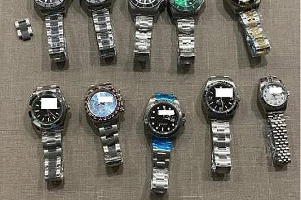 DIRAMPAS: Sebanyak 51 barangan mewah palsu termasuk jam dan aksesori jam bernilai sekitar $11,000 dirampas. - Foto-foto SPF