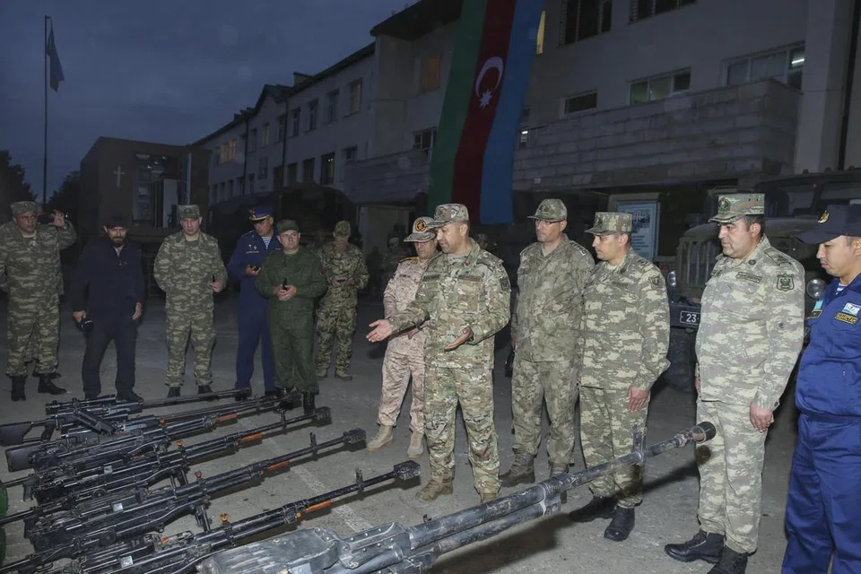SERAH SENJATA: Para anggota Azerbaijan memeriksa senjata yang dirampas dan diserahkan oleh kumpulan pemisah Nagorno-Karabakh pada Sabtu.