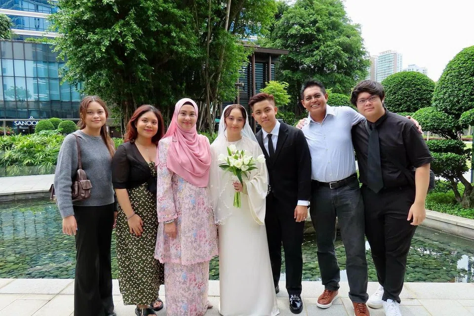 Hosni (dua dari kanan) dan isterinya, Norlinda Ses (tiga dari kiri), bergambar bersama anggota keluarga di majlis perkahwinan anak sulung mereka, Nadia Alya, dengan pasangannya, Nahyan Gabriel Loh, pada Oktober 2024.