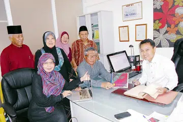 REDAKSI BUKU 'MASYARAKAT BAWEAN SINGAPURA LA-A-OBE': (Duduk dari kiri) Cik Sundusia, Haji Asmawi Majid dan Haji Faizal serta (berdiri dari kiri) Haji Mohd Seain, Cik Rohanah Pagi, Cik Nurul Sa'adah Mohammad Seain dan Haji Morni Sulaiman. - Foto SAINI SALLEH