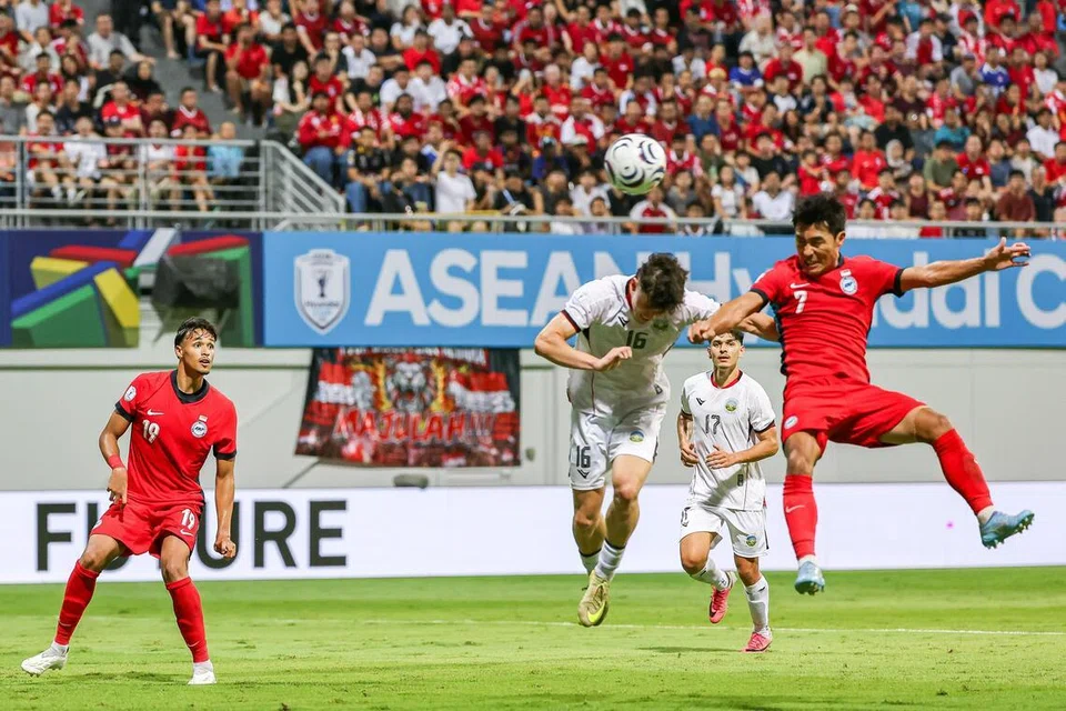 Pemain tengah Singapura, Song Ui-young (kanan), menanduk masuk gol kedua buat skuad Singa semasa separuh masa kedua menentang Timor-Leste di Stadium Jalan Besar.