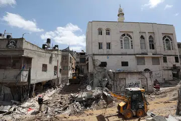 Warga Palestin melihat dari dekat kerosakan yang ditimpakan tentera Israel di kem pelarian di Nur Shams pada 21 April. 