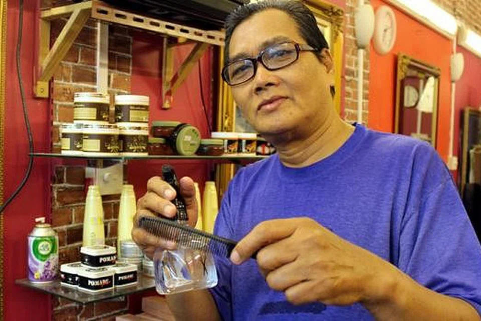 TIDAK MAHU KETINGGALAN: Encik Zainal Abidin Dahlan, tukang gunting di kedai Hj Osnam Malay Barber Shop, masih mempelajari trend rambut terkini untuk memenuhi keperluan pelanggan.