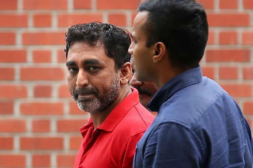 Zackeer Abbass Khan (merah) dibawa ke sebuah kedai kopi di Serangoon Avenue 2, tempat rancangan menyerang penyelia Restoran Victory dipercayai dirancang. 