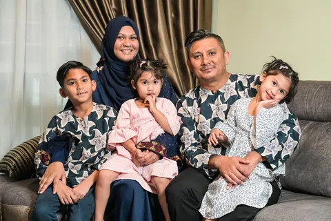 Cik Dayana memangku anak-anaknya Mohamad Dhaffir Rafael (kiri) dan Mikayla Nazra (tengah) bersama suaminya Encik Mohamad Ridhwan Shahul Hamid (kanan) yang mendukung anak mereka Mikayla Sabira.
