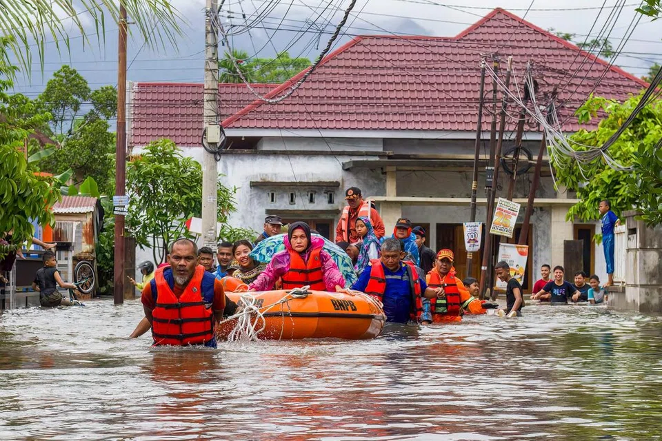 Para anggota penyelamat memindahkan para penduduk yang terjejas dek banjir besar dan tanah runtuh yang melanda Padang, Sumatra Barat pada 25  November 2025.