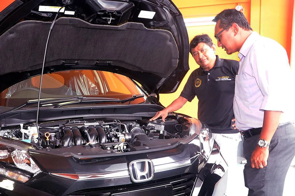 KEMBANG NIAGA: Encik Hanip (kiri) mahu memanfaatkan pangkalan pelanggannya yang ramai di Hanip Automobiles bagi perniagaan barunya, Prominence Motors, yang diuruskan oleh adiknya, Encik Mohd Noor (kanan). - Foto JOHARI RAHMAT