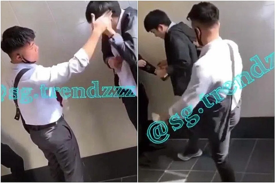 DIBUANG SEKOLAH: Pelajar (berbaju putih), yang dilihat dalam satu video sedang membuli seorang pelajar lain (memakai jaket hitam) dengan merampas pelitup mangsa dan memukul kepala mangsa, telah dibuang sekolah. - Foto SG.TRENDZZZ/INSTAGRAM