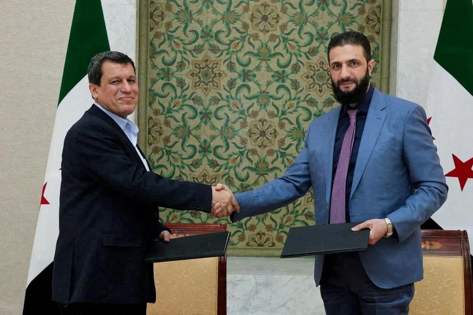 Presiden sementara Syria, Ahmed al-Sharaa dan Komander Pasukan Demokratik Syria (SDF) yang diketuai etnik Kurdi, Mazloum Abdi, berjabat tangan selepas Syria mencapai persetujuan untuk menyepadukan SDF ke dalam institusi-institusi negara. Gambar ini dirakam di Damsyik dan diedarkan oleh Pejabat Presiden Syria pada 10 Mac 2025.