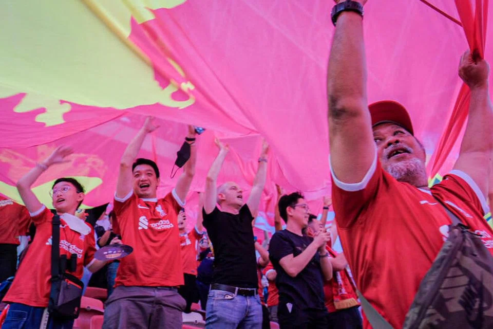 BERSEMANGAT: Penyokong Liverpool mengibarkan sepanduk besar kelab sambil menyanyikan lagu ‘You’ll Never Walk Alone’ sebelum perlawanan persahabatan The Reds menentang Bayern Munich di Stadium Negara pada Rabu malam.