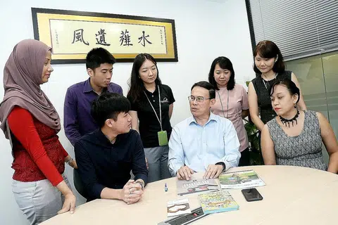 BINCANG CARA TARIK PENYERTAAN MASYARAKAT: Dr Teo (berkemeja cerah, tengah) berbincang dengan kakitangan CDC North West cara terbaik mengendalikan aktiviti untuk menarik minat masyarakat di kawasan itu.