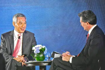 BINCANG ISU SERANTAU: Encik Lee menjawab beberapa soalan yang dikemukakan hadirin di dialog semasa jamuan malam sempena Forum Ekonomi Baru Bloomberg. Moderator dialog itu adalah ketua editor Bloomberg News John Micklethwait (kanan). - Foto BH oleh ARIFFIN JAMAR