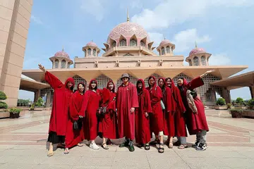 KENANGAN DI MALAYSIA: Para pelancong dari Jepun merakamkan gambar kenangan berlatar belakangkan Masjid Putra. - Foto BERNAMA