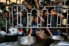 Kanak-kanak Palestin menunggu makanan di sebuah dapur amal di kawasan Mawasi, Khan Yunis, selatan Jaluran Gaza pada 22 Julai 2025. Ketua hospital terbesar di Gaza memaklumkan bahawa seramai 21 kanak-kanak telah meninggal dunia akibat kekurangan zat makanan dan kebuluran dalam tempoh tiga hari lalu, di tengah-tengah serangan dahsyat oleh tentera Israel. 