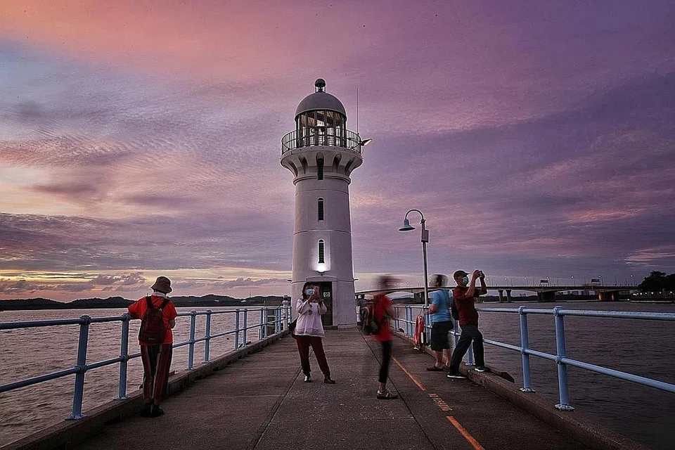 RUMAH API RAFFLES MARINA: Rona merah jambu dan merah senduduk memberi aura romantik kepada rumah api yang terletak di tembok penahan ombak di kelab Raffles Marina, yang menghadap Laluan Kedua Tuas tatkala mentari terbenam. - Foto BH oleh GIN TAY