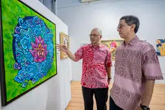 KARYA TEKNOLOGI: Profesor Madya Dr Muhammad Faishal Ibrahim (kanan) mengamati salah sebuah lukisan dalam pameran, Seni Kita 2023, bersama penganjur bersama yang juga juri, Encik Kamal Dollah.