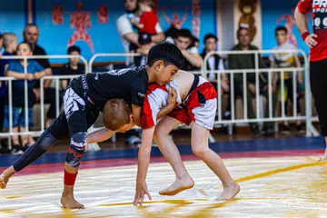 WARGA PERTAMA: Pada usia sembilan tahun, Rumi Rangkayo Noorman (kiri) dipercayai merupakan warga Singapura pertama yang menyertai kejohanan sukan gusti, atau ‘grappling’ di Dagestan, Russia.