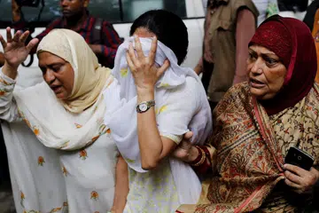 BERKABUNG: Penduduk melahirkan rasa sedih selepas pengganas menyerang sebuah kafe di Dhaka, Bangladesh. - Foto Reuters