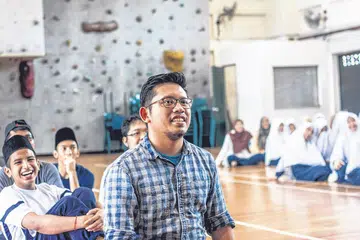 SUMBANG SEMULA: Encik Masagos (depan) senang dapat meyumbang bakti kepada program AAM di Madrasah Aljunied Al-Islamiah yang sebelum ini telah membantu adik-adiknya dalam persiapan peperiksaan GCE peringkat 'O' mereka tidak lama dulu. - Foto FACEBOOK AAM