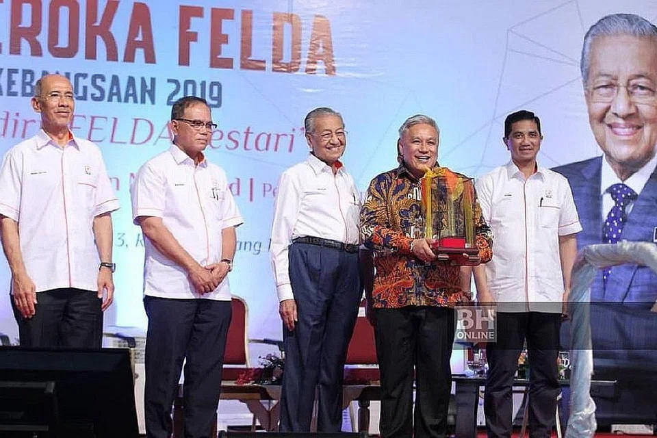 INSPIRASI: Perdana Menteri Malaysia, Tun Dr Mahathir Mohamad (tengah) menyampaikan Anugerah Ikon Anak Felda kepada selebriti Cef Wan pada Sambutan Hari Peneroka Kebangsaan 2019 di Padang Awam, Felda Selancar 3, Rompin. Turut hadir, Menteri Hal Ehwal Ekonomi, Datuk Seri Mohamed Azmin Ali. - Foto NSTP