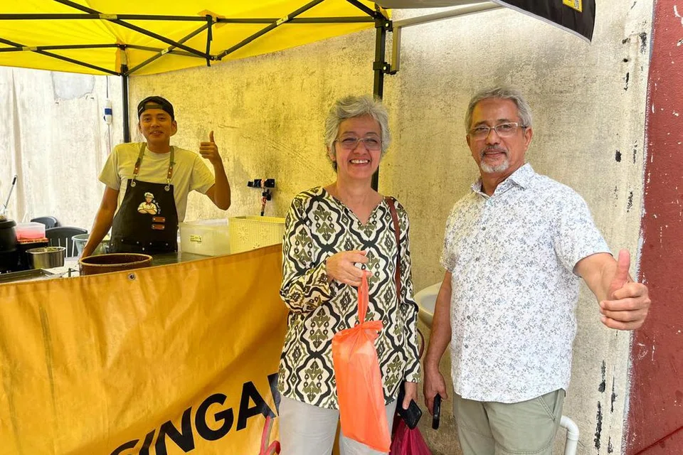 Encik Mohd Daniel Shukor, 34 tahun (kiri), bersama pelanggan ‘Murtabak Singapore Dari Rumah’ asal Singapura, Cik Fadhlon Alkaff, 65 tahun (tengah), dan suaminya, yang kini menetap di Kuala Lumpur.