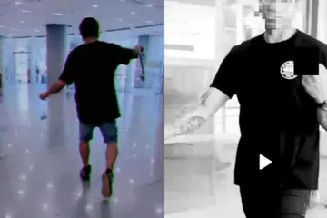 RAKAMAN TERLARANG: Video menunjukkan Mohd Heirizal Kamarzaman berjalan dengan gaya samseng dan membuat tanda lucah dengan tangannya.