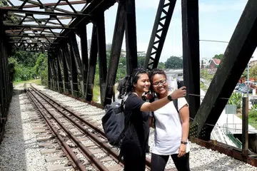 SELFIE UNTUK INSTAGRAM: Cik Nur Erni Sufiana Abdul Hamid (kanan) dan Cik Ily Dayana Kamsol bergambar dengan berlatarbelakangkan jambatan ikonik di Koridor Kereta Api untuk dimuat naik ke dalam Instagram mereka. - Foto KHALID BABA