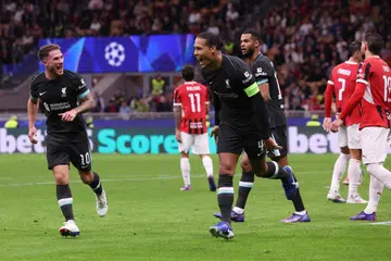 Kapten Liverpool, Virgil van Dijk (tengah), meraikan jaringan gol kedua Liverpool ke atas AC Milan. Di kiri ialah Alexis Mac Allister