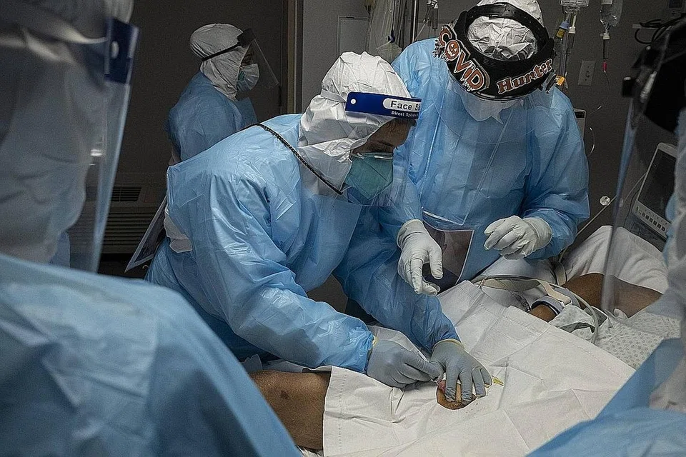 JANGKITAN BELUM REDA: Kakitangan perubatan memberikan rawatan ke atas pesakit Covid-19 di unit kecemasan di United Memorial Medical Center minggu lalu di Houston, Texas. - Foto AFP