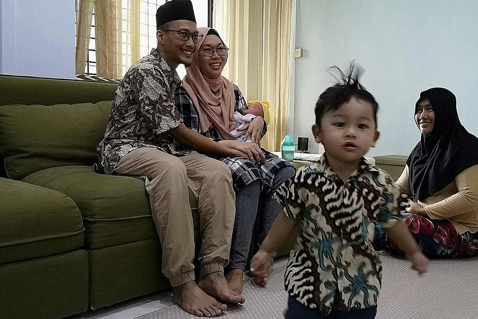 PERLU BANTUAN: Dengan anak perempuan yang baru dilahirkan dua minggu dan anak lelaku berusia setahun, Cik Nurayu (dua dari kiri) dan suaminya, Encik Mohamad Shaifuddin Masdar, melahirkan perasaan bersyukur kerana mendapat seorang pembantu rumah, yang mahu dikenali hanya sebagai Cik Su (kanan), untuk membantu mereka menguruskan kerja rumah. - Foto ihsan NURAYU SAFARUAN