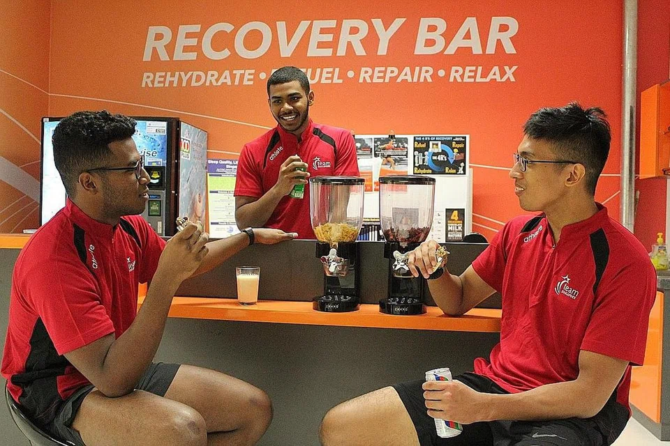 BANTU ATLIT: Produk berkhasiat F&N dan Nestle membantu persiapan atlit Team Singapore seperti tiga pesilat negara ini, (dari kiri) Sheik Ferdous Sheik Alau'ddin, Sheik Farhan dan Nur Alfian, terutama dari segi kesihatan dan proses pemulihan mereka. - Foto SPORTSG